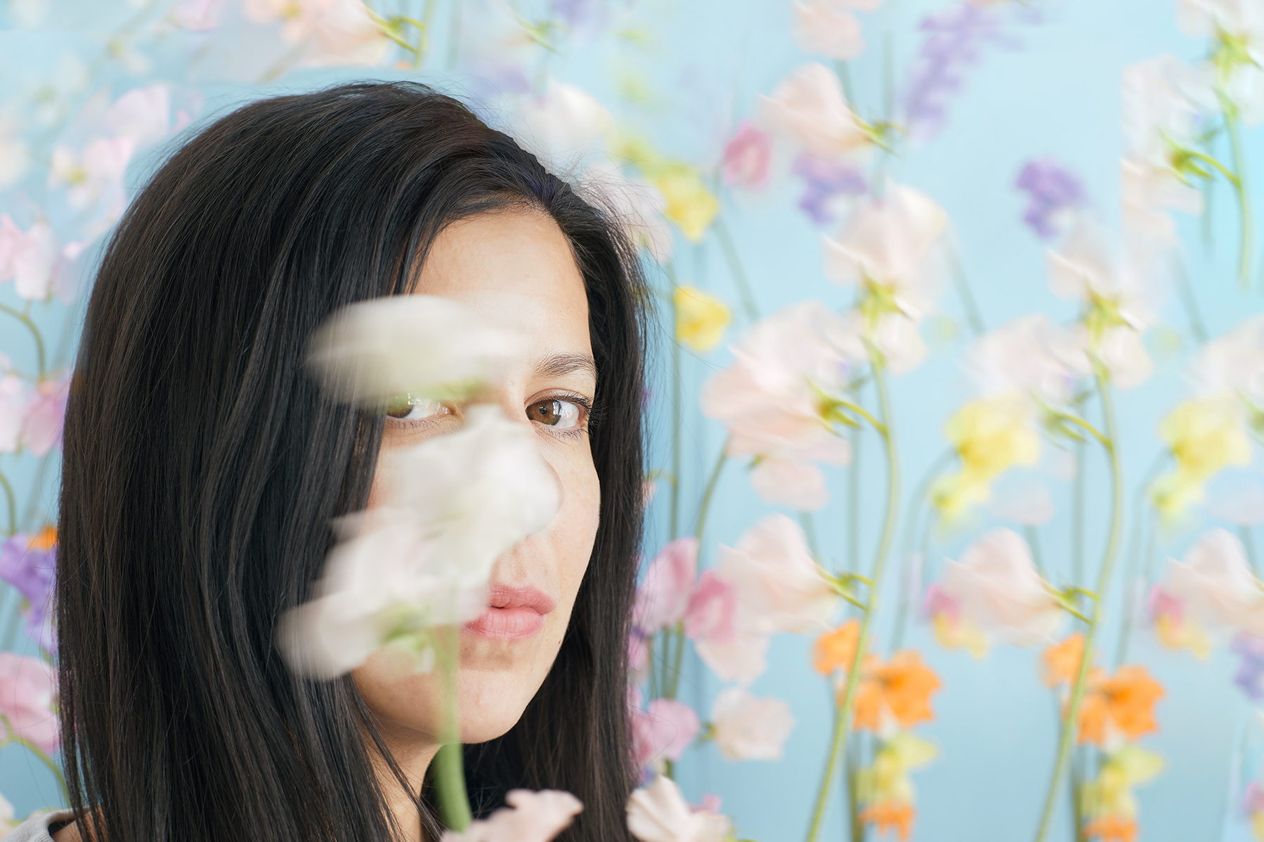 Artist self-portrait with candy hued sweet peas.