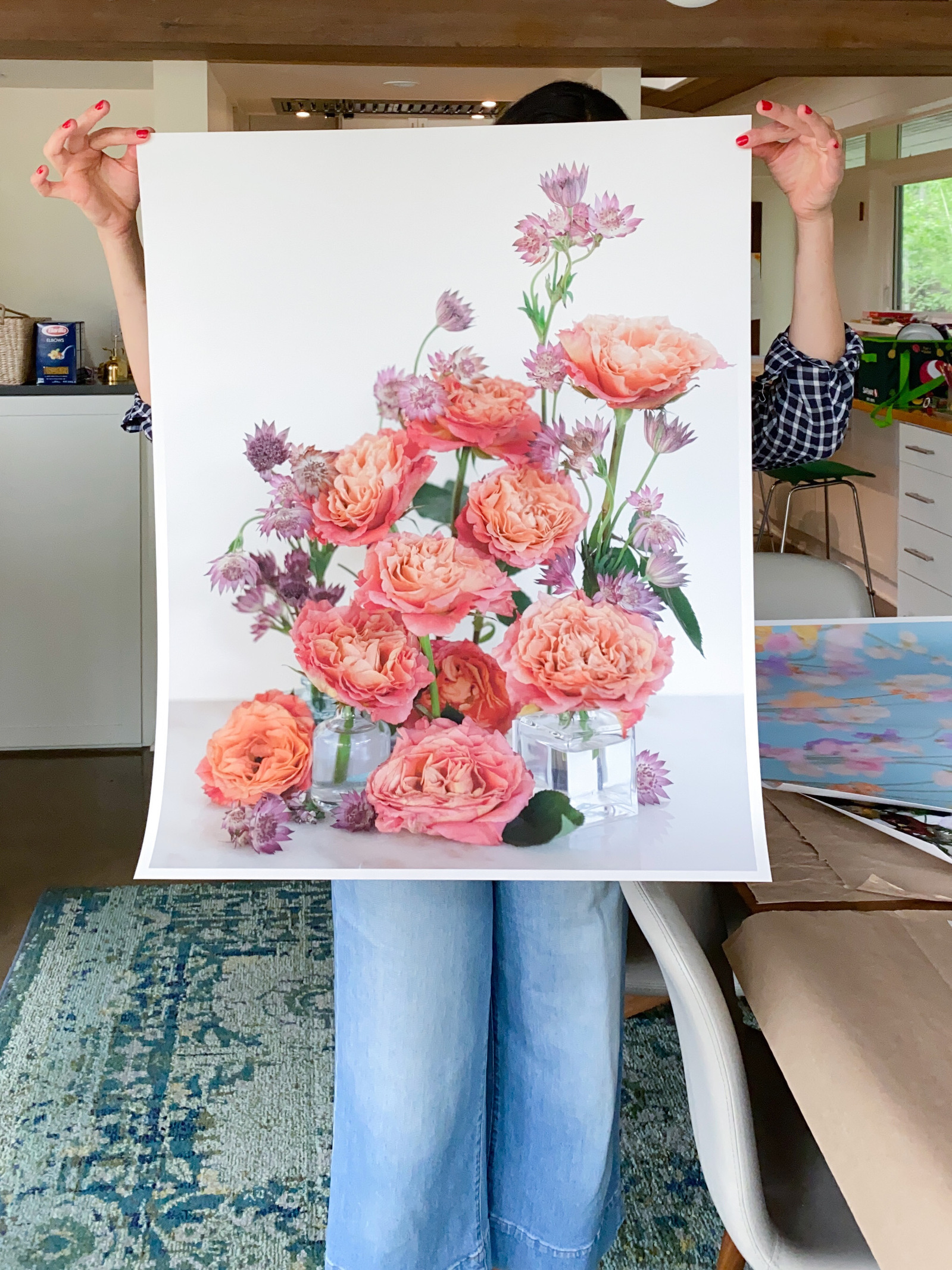 Artist holding up fine art print. 