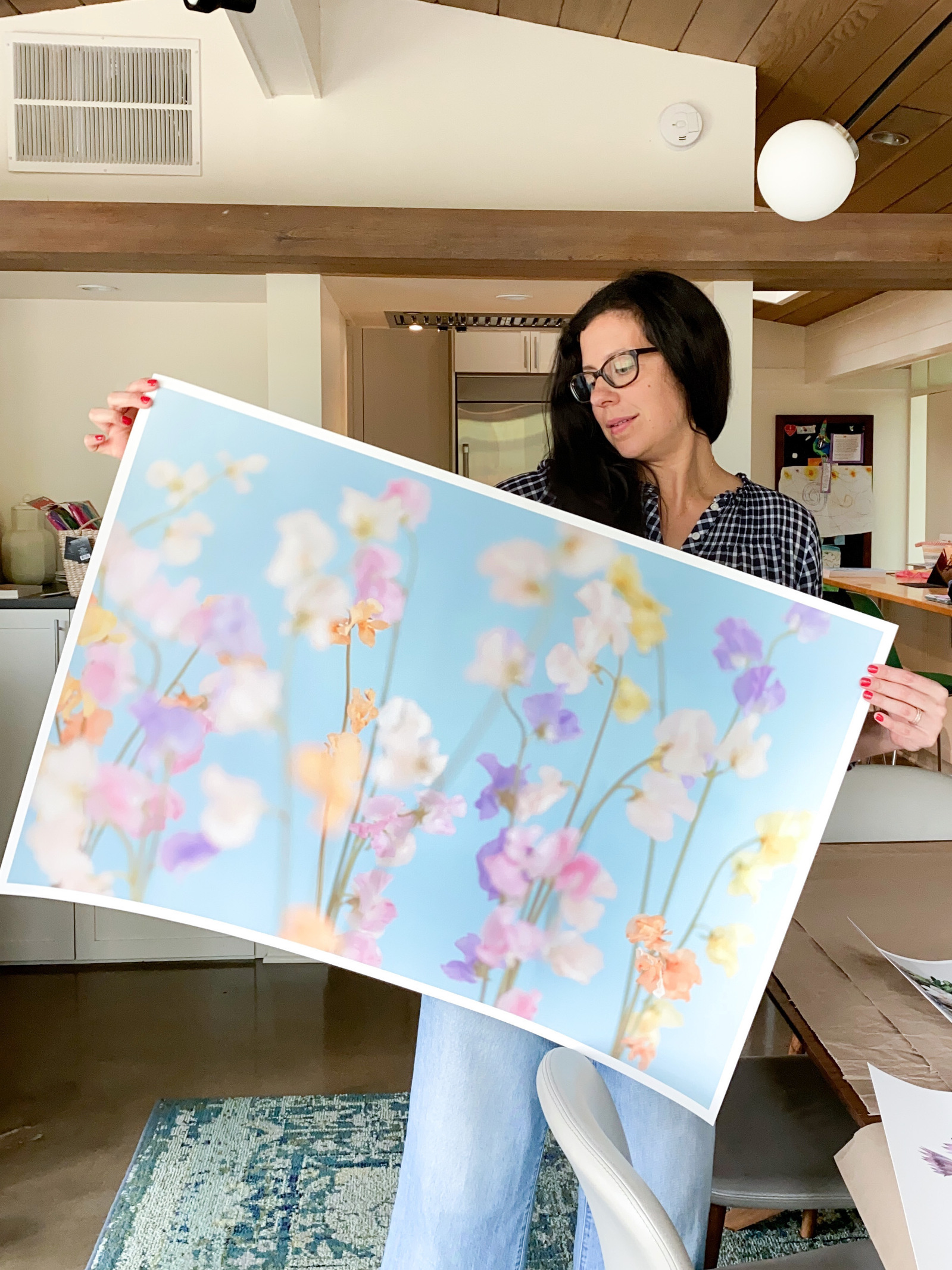 Artist holding up fine art print. 