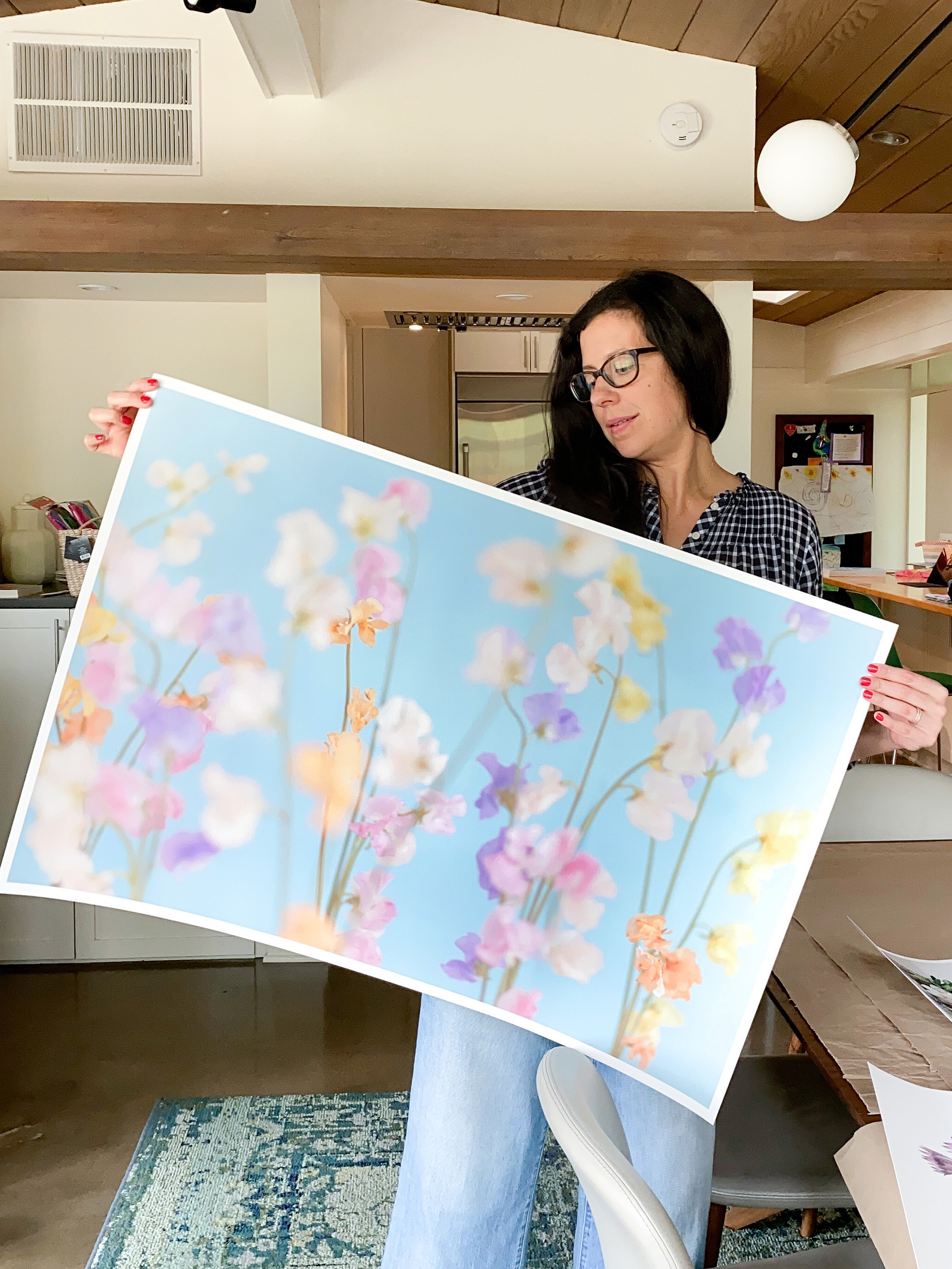 Artist holding up fine art print. 
