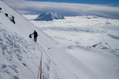 Climbers descending the west ridge of Denali or Mount McKinley in Alaska. Mount Sultana is seen in the background.