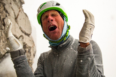 Conrad Anker celebrating successfully climbing a ice climbing route without falling on the rope.