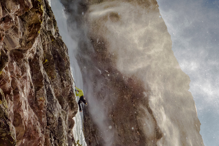 Noah Ronczkowski climbing "Responsible Family Men" 60M WI5 on a blustery January day. Hyalite Canyon Montana
