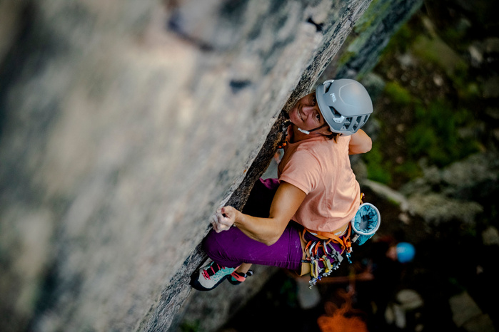 Climbing in the Gallatin Canyon, Montana. A Canyon test piece - "The Fugitive" 12.a Anne Gilbert Chase climbs this colorful north facing traditional line and clips the chains on this day in the Custer Gallatin National Forest.