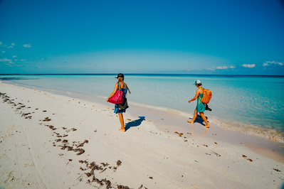 Two women walk along the beaches of Vinales Cuba