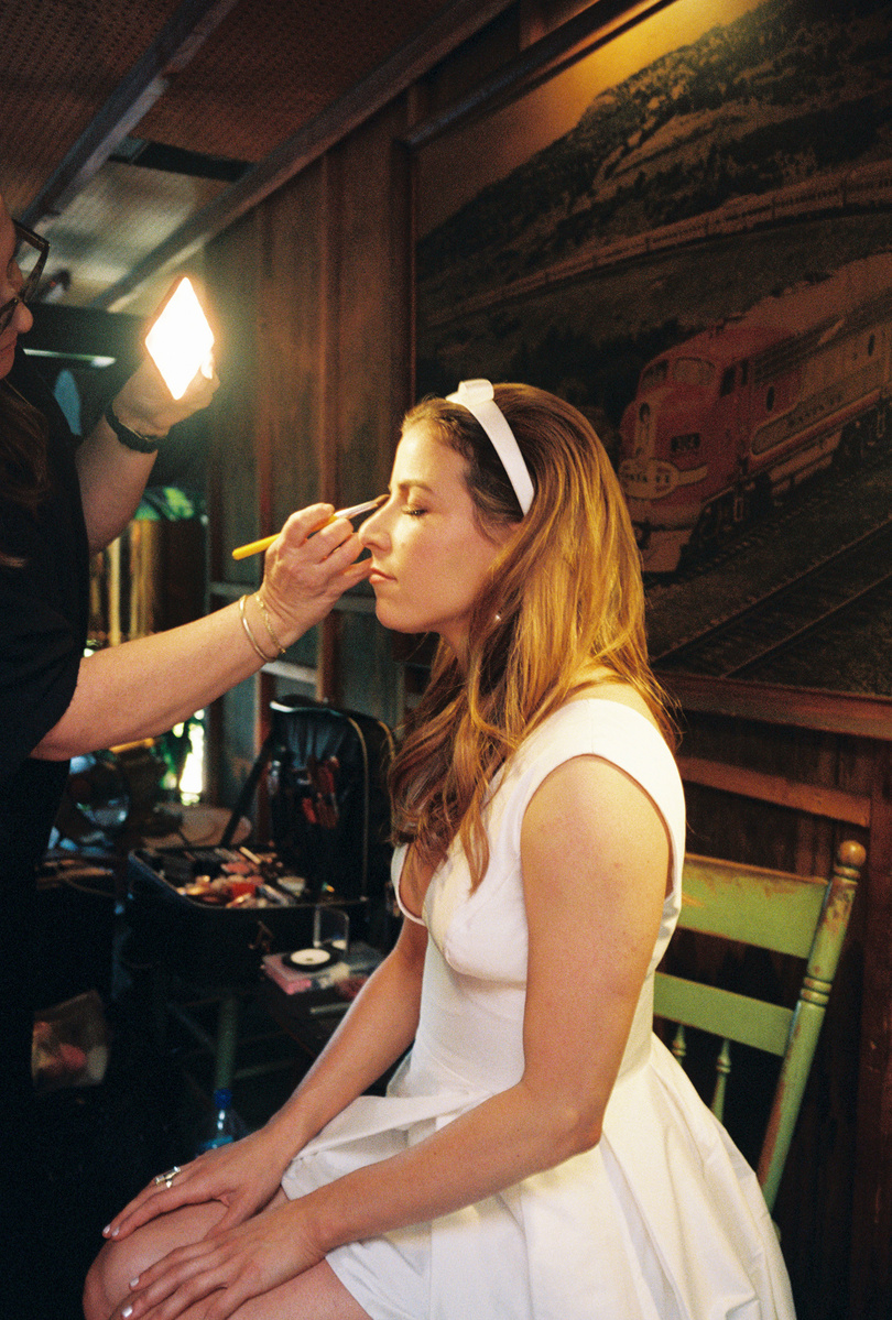 Candid bride shot on film during makeup touch-up, captured by Abigail Gorden Photography. A beautiful behind-the-scenes wedding moment.