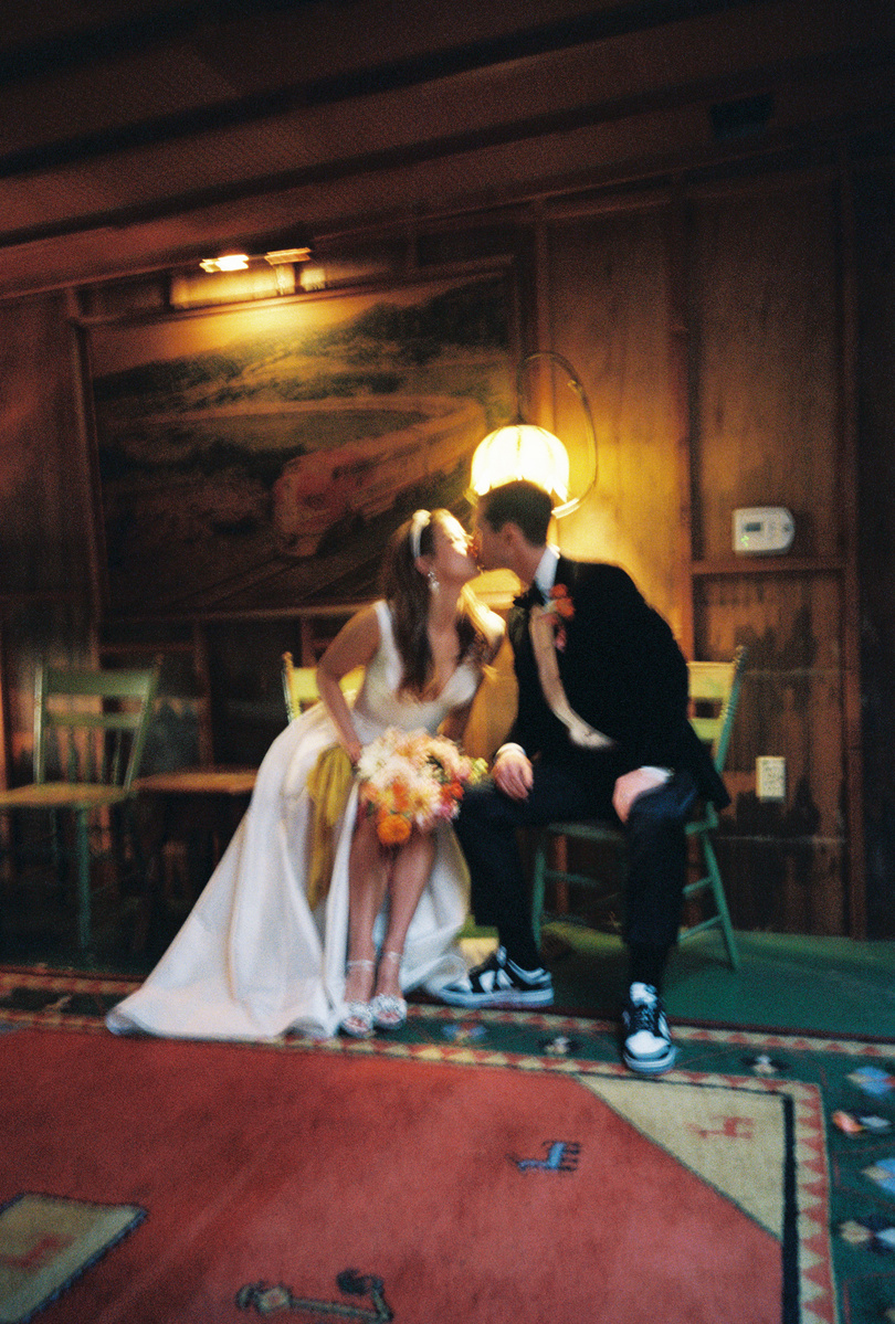 Intimate kissing film shot of bride and groom, captured by Abigail Gorden Photography. A romantic and heartfelt moment on their wedding day.