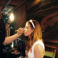 Candid bride shot on film during makeup touch-up, captured by Abigail Gorden Photography. A beautiful behind-the-scenes wedding moment.