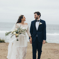 Romantic wedding photography of a bride and groom walking on the beach in Malibu, CA.