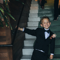 Cute candid photo of a little kid ring bearer at a wedding.