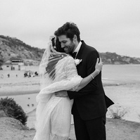 Black and white wedding photography of a first look moment with bride and groom shot in Malibu, California.