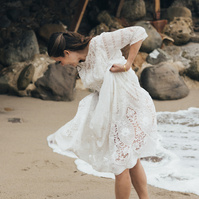 Candid wedding photography of a bride shot at the beach in Duke's Malibu, California by Los Angeles-based wedding photographer Abigail Gorden Photography.
