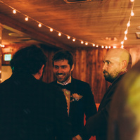 Wedding photography of a groom on the dance floor surrounded by friends on his wedding day at Duke's Malibu in California.