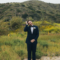 Wedding photography of groom waiting for bride on an overcast wedding day in Malibu, California.