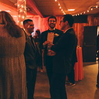 Wedding photography of a groom on the dance floor surrounded by friends on his wedding day at Duke's Malibu in California.