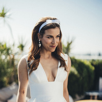 Bride smiling atop the Shay Hotel on her wedding day by Abigail Gorden.