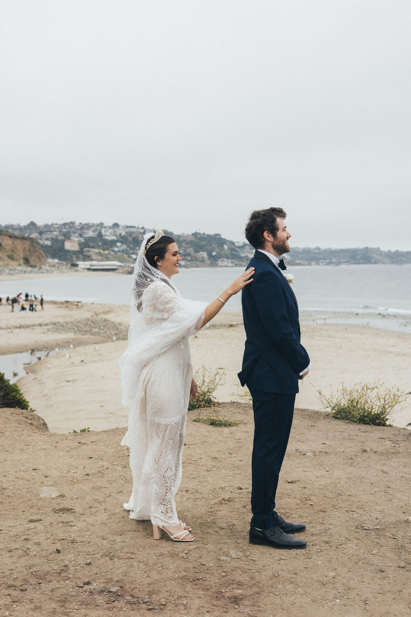 Wedding photography of a first look moment with bride and groom shot in Malibu, California.