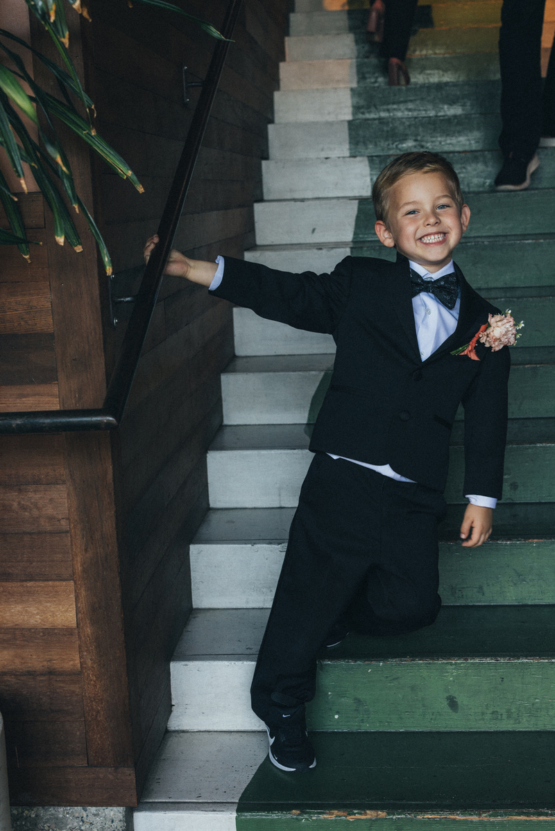 Cute candid photo of a little kid ring bearer at a wedding.