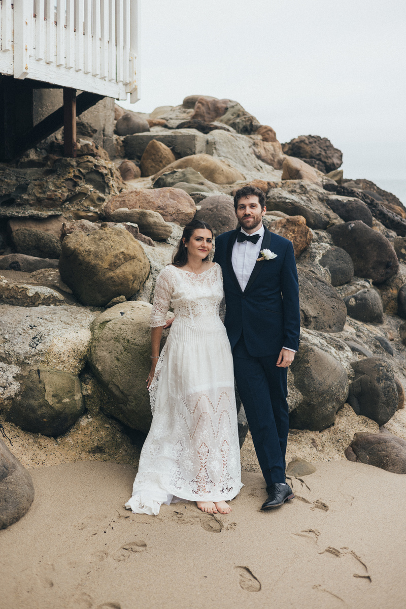 Wedding photography of bride and groom shot at the beach in Duke's Malibu, California by Los Angeles-based wedding photographer Abigail Gorden Photography.