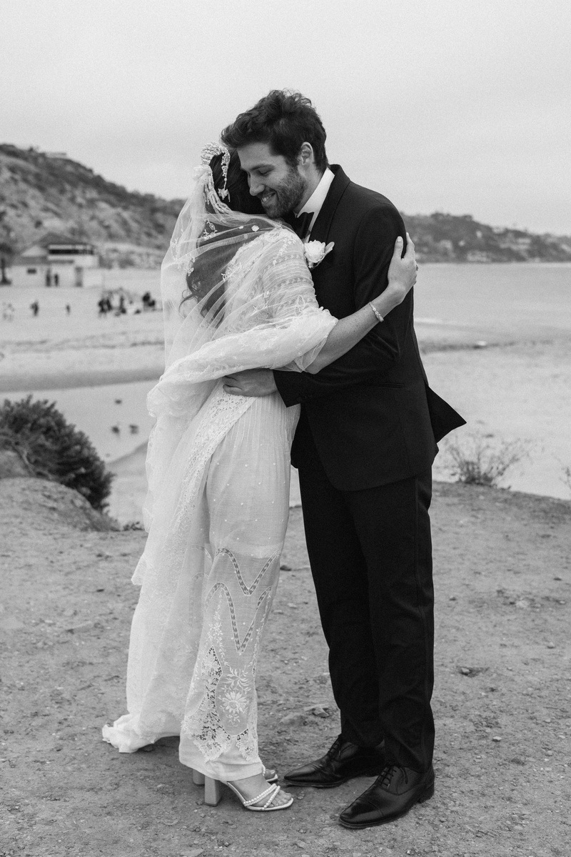 Black and white wedding photography of a first look moment with bride and groom shot in Malibu, California.