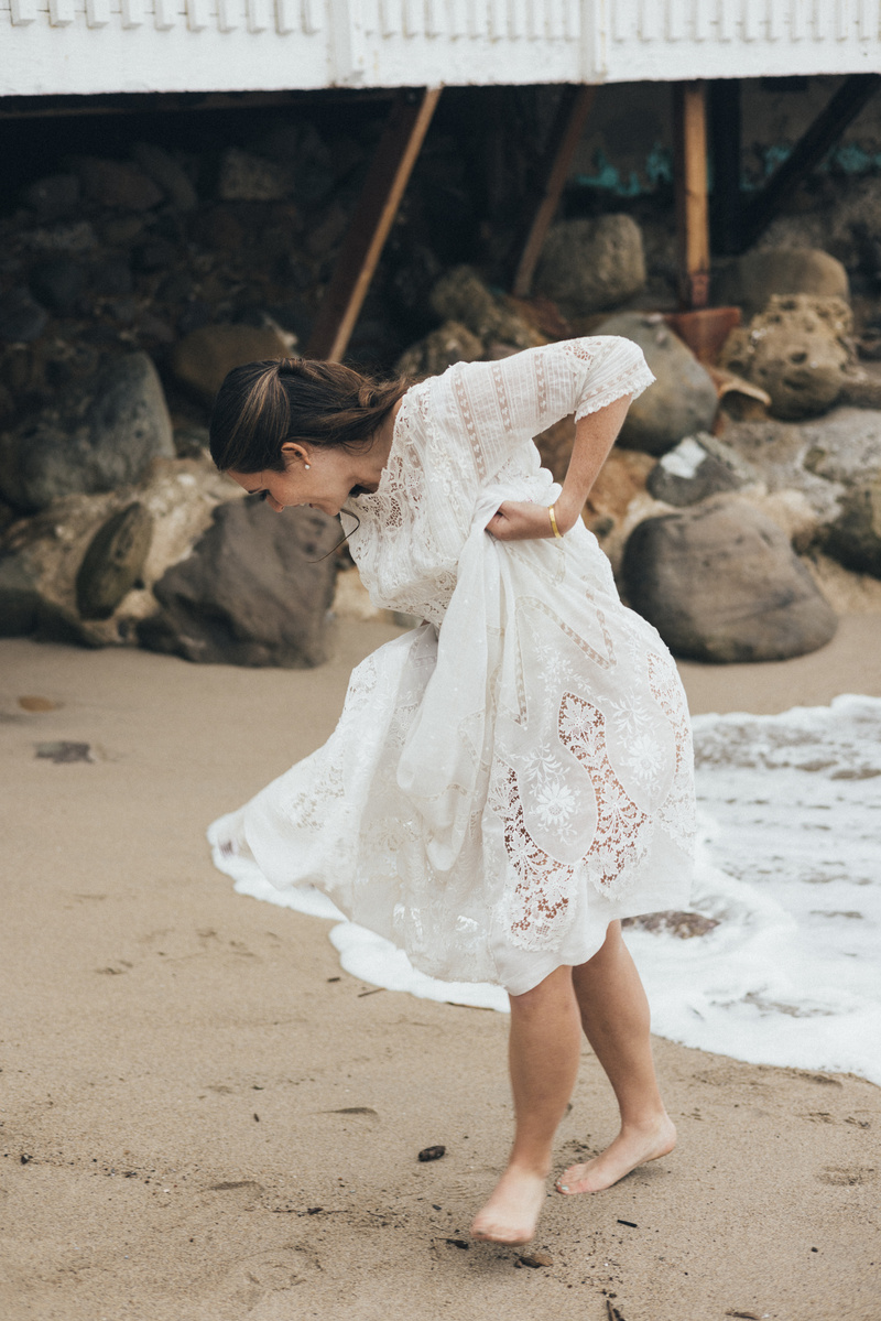 Candid wedding photography of a bride shot at the beach in Duke's Malibu, California by Los Angeles-based wedding photographer Abigail Gorden Photography.