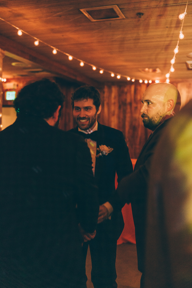 Wedding photography of a groom on the dance floor surrounded by friends on his wedding day at Duke's Malibu in California.