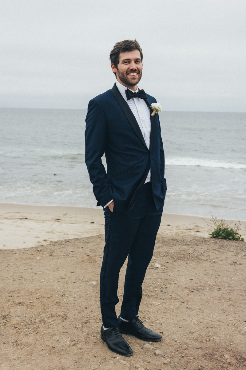 Wedding photography of groom waiting for bride on an overcast wedding day in Malibu, California.