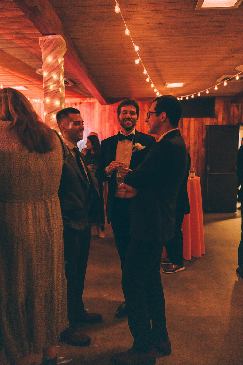 Wedding photography of a groom on the dance floor surrounded by friends on his wedding day at Duke's Malibu in California.