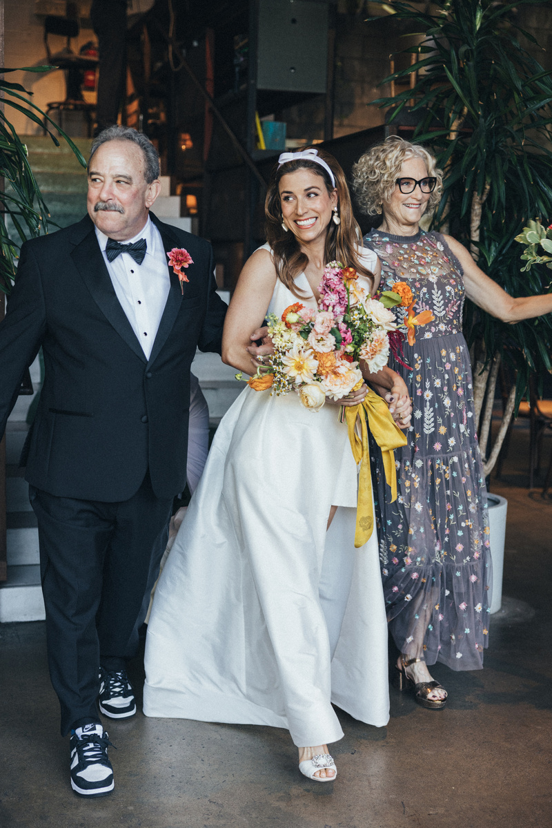 Candid parents walking the bride to the altar, captured by Abigail Gorden Photography. A heartfelt and emotional moment at the wedding ceremony.