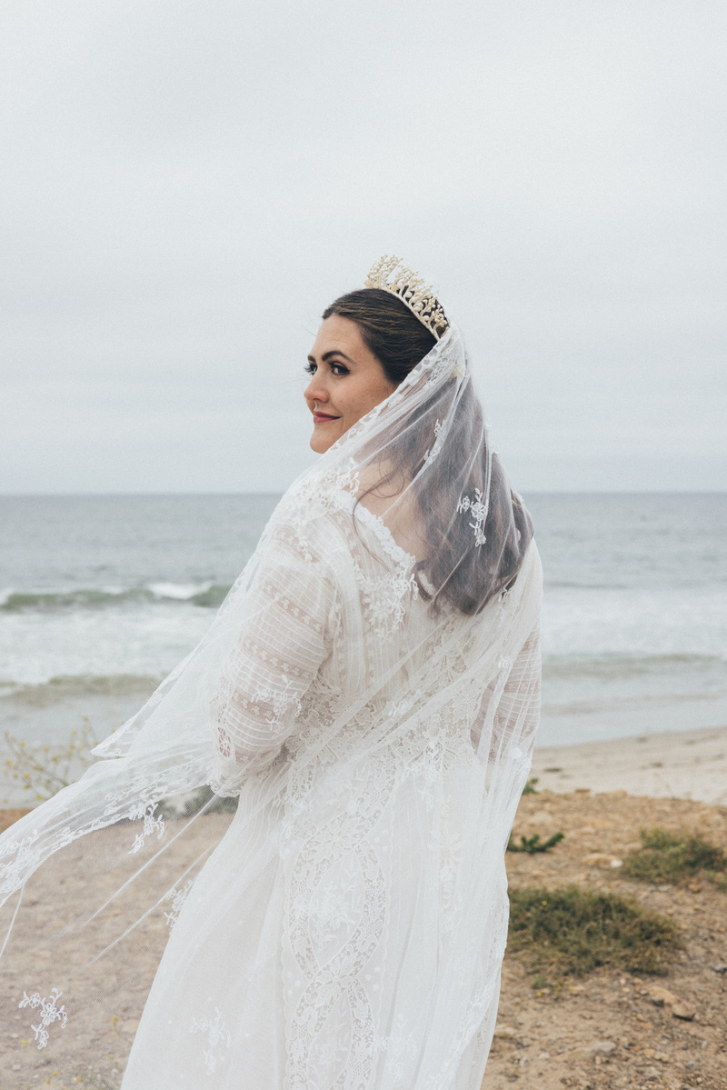 Beautiful bride photographed on her wedding day on the beach in Malibu, CA.