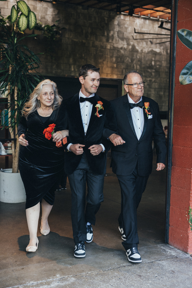 Candid parents walking the groom to the altar, captured by Abigail Gorden Photography. A heartfelt and emotional moment at the wedding ceremony.