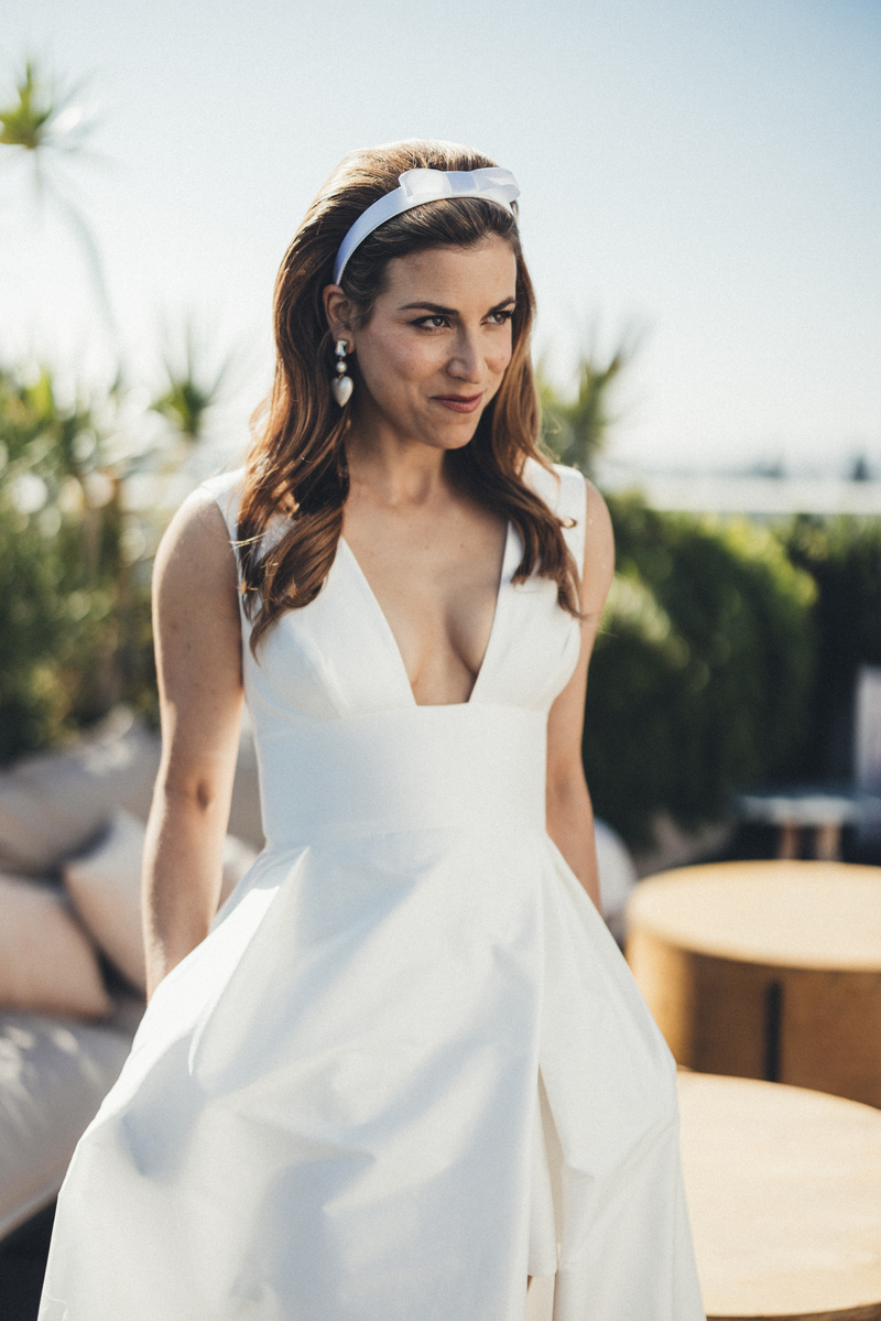 Bride smiling atop the Shay Hotel on her wedding day by Abigail Gorden.