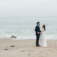 Wedding photography of bride and groom shot at the beach in Duke's Malibu, California by Los Angeles-based wedding photographer Abigail Gorden Photography.