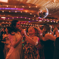 Wedding photography of a bride and her friend dancing on her wedding day by wedding photographer Abigail Gorden.