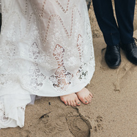 Wedding photography detail shot of bride and groom shot at the beach in Duke's Malibu, California by Los Angeles-based wedding photographer Abigail Gorden Photography.