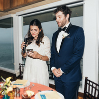 Flash wedding photography of newly married bride and groom giving a speech at Duke's Malibu.