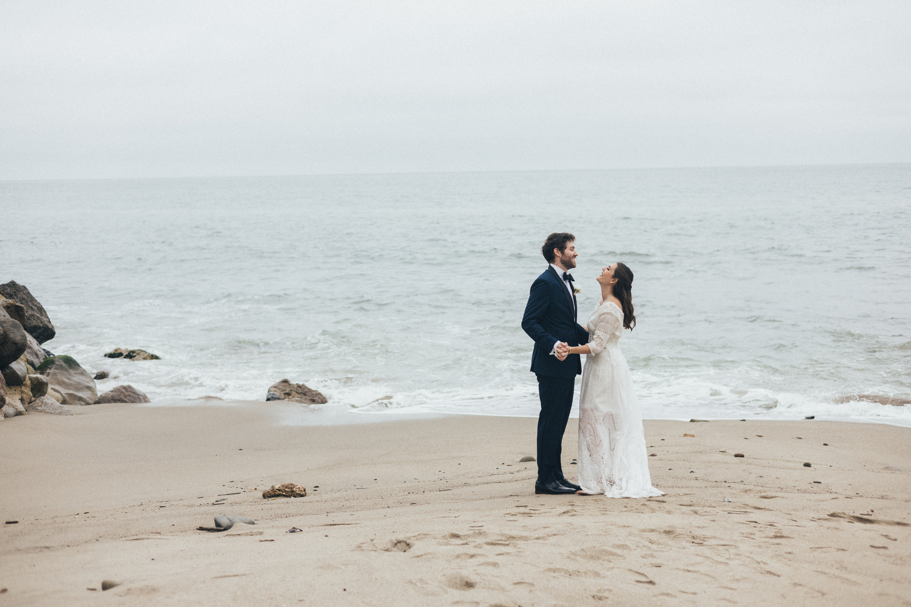 Wedding photography of bride and groom shot at the beach in Duke's Malibu, California by Los Angeles-based wedding photographer Abigail Gorden Photography.