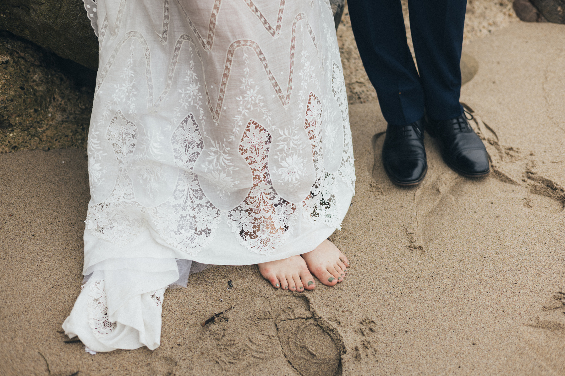 Wedding photography detail shot of bride and groom shot at the beach in Duke's Malibu, California by Los Angeles-based wedding photographer Abigail Gorden Photography.