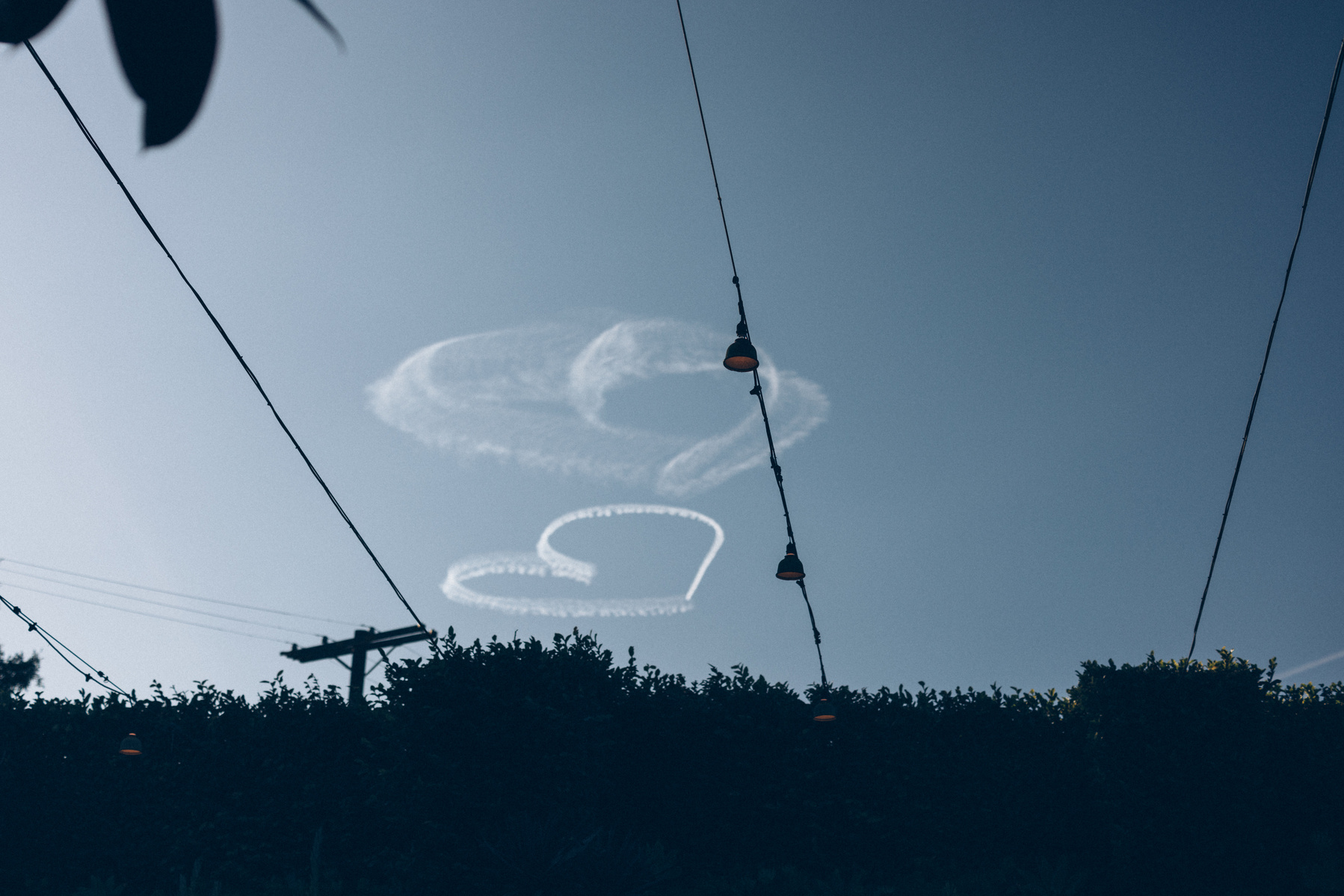 Hearts in the sky wedding photo, captured by Abigail Gorden Photography. A dreamy and romantic moment above the celebration.