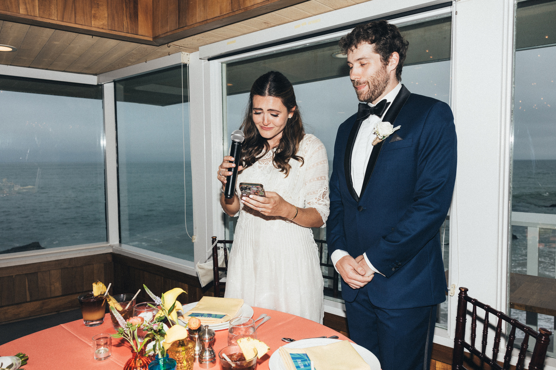Flash wedding photography of newly married bride and groom giving a speech at Duke's Malibu.