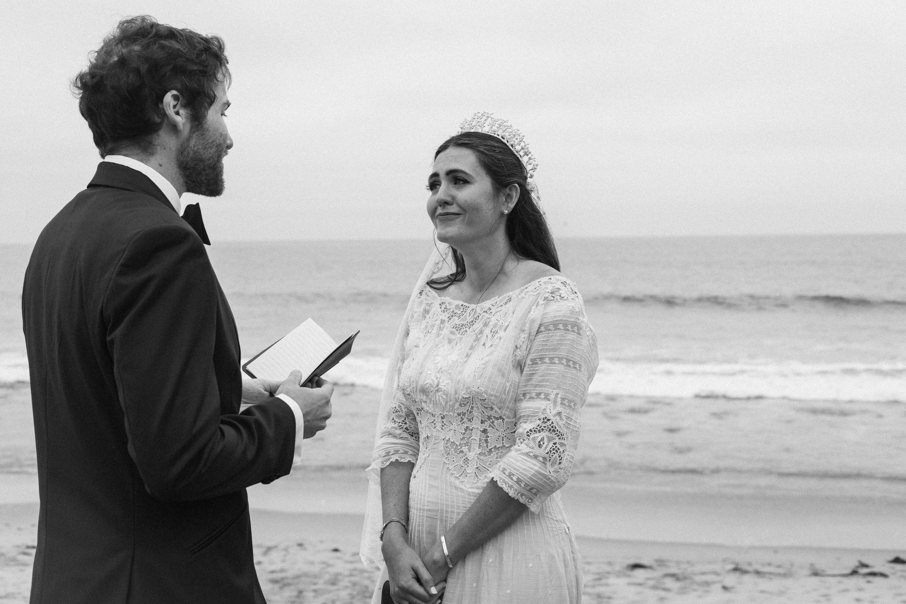 Romantic and intimate black and white wedding photography of a bride and groom exchanging vows in Malibu, CA.