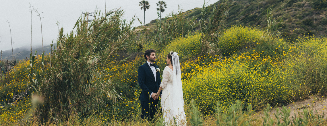 Wedding ceremony photography with coastal views on Malibu Beach, California.