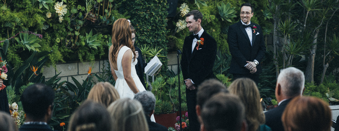 Bride and groom exchanging vows at their wedding ceremony at The SmogShoppe, captured by Abigail Gorden Photography. A beautiful moment of love and commitment.