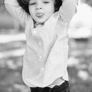 Boy sticks out tongue