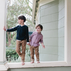 Boys stand on front porch together