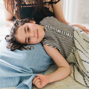 Girl lays head in moms lap