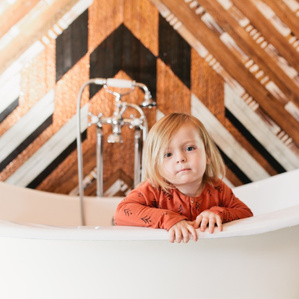 Boy sits in tub at Urban Cowboy BNB