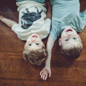 Boys lay together on ground