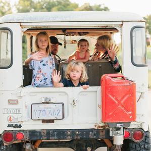 Family sits in vintage truck together