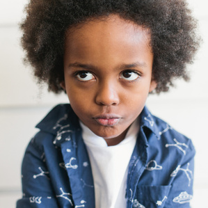 Boy makes silly face and rolls eyes